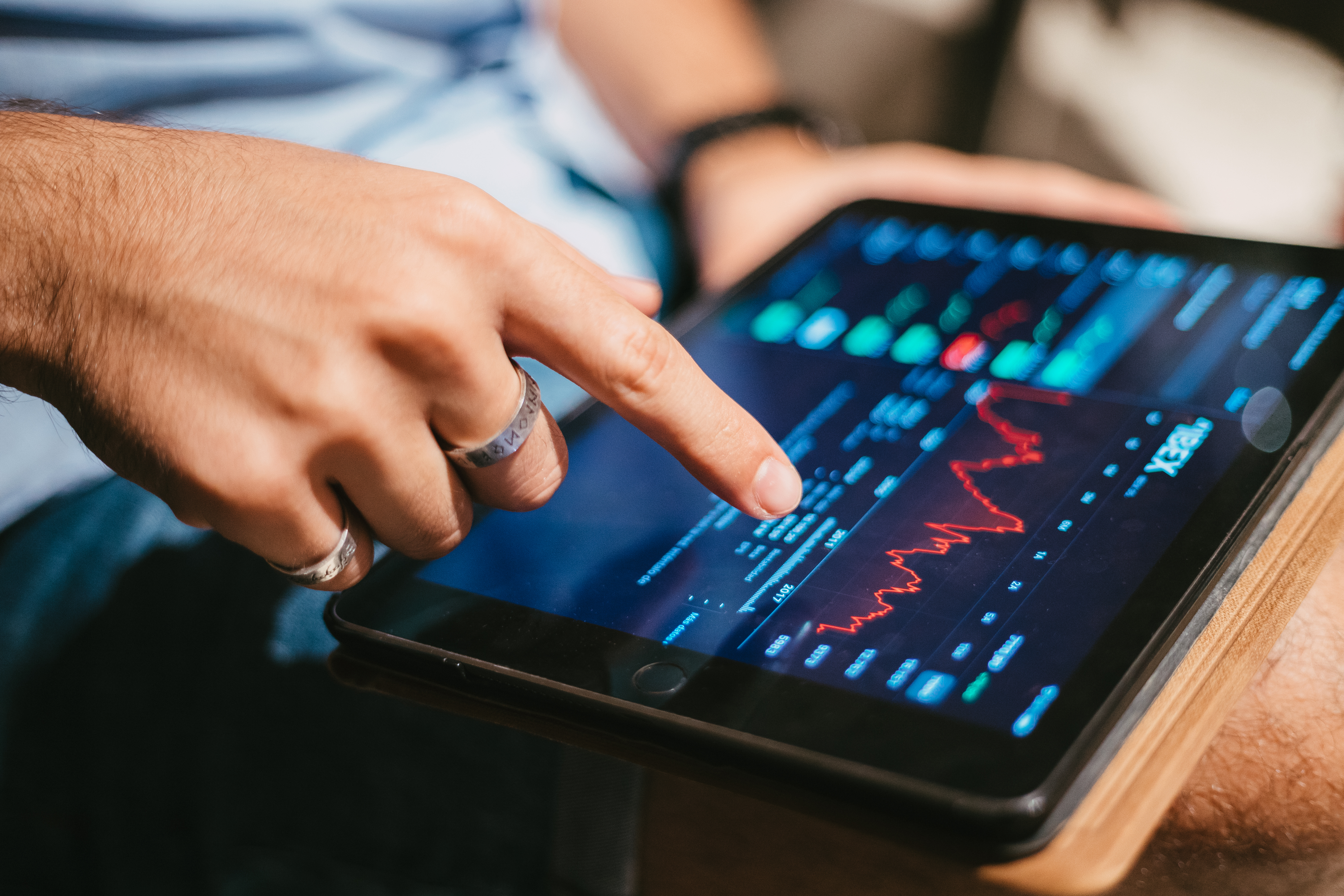 man-checking-stock-market-data-tablet