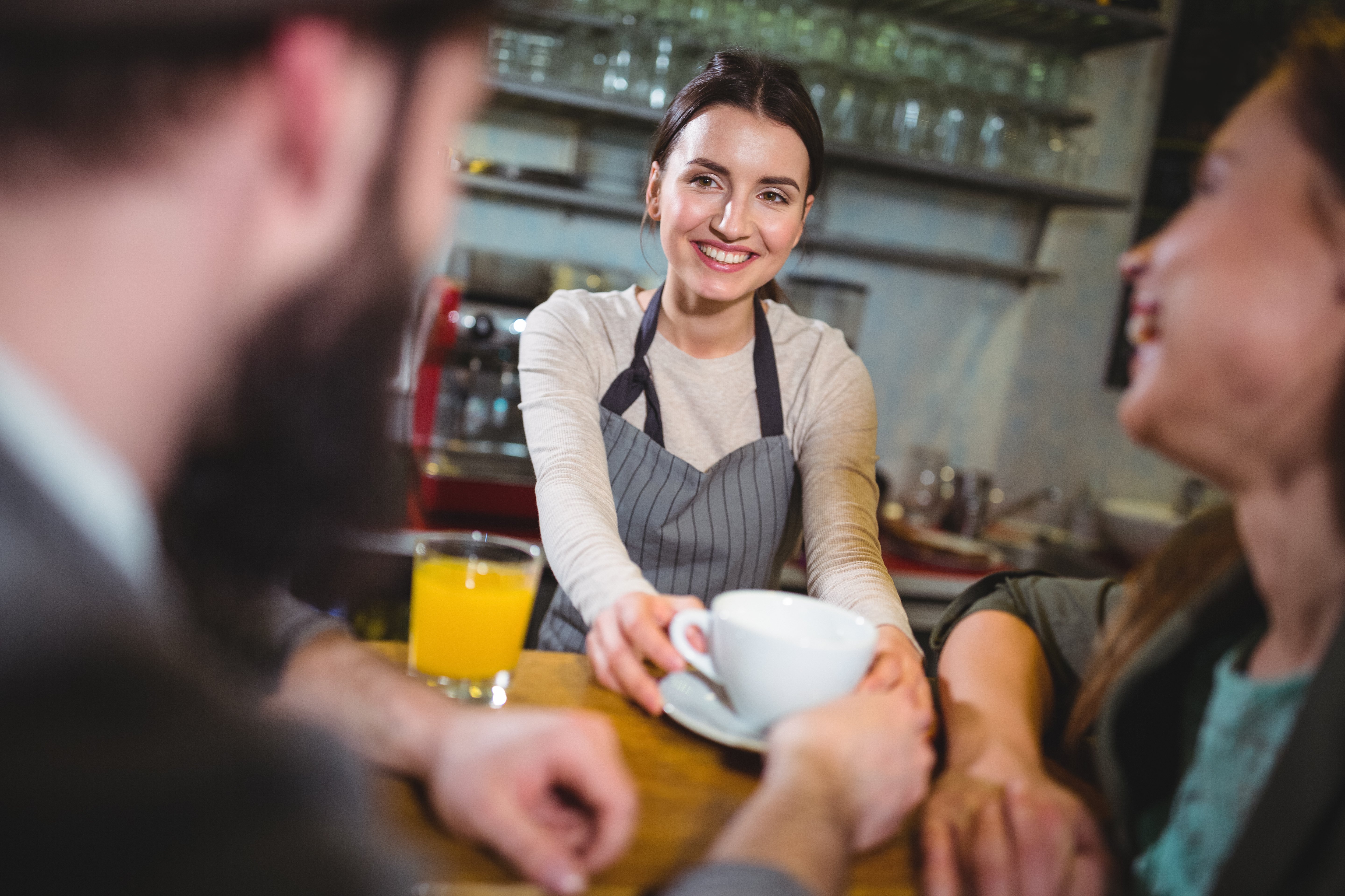 waitress-serving-cup-coffee-customers